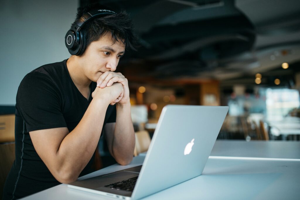 Man watching something on a laptop